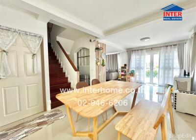 Spacious living area with dining table and staircase