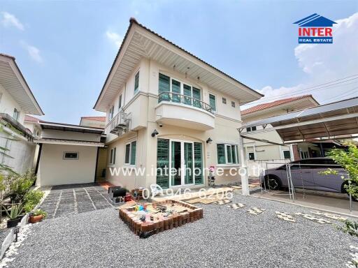 Two-story house with driveway and garden