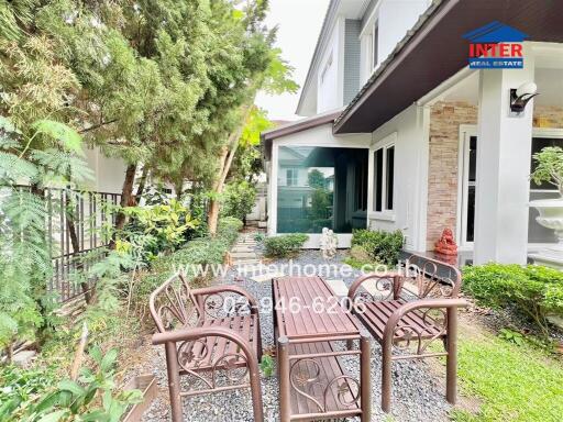 Outdoor seating area in a garden with furniture and pergola