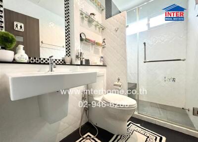 Modern bathroom with white fixtures and glass shower