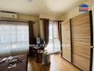 Bedroom with large window and wooden wardrobe