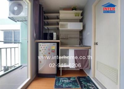 Compact kitchen area with balcony access