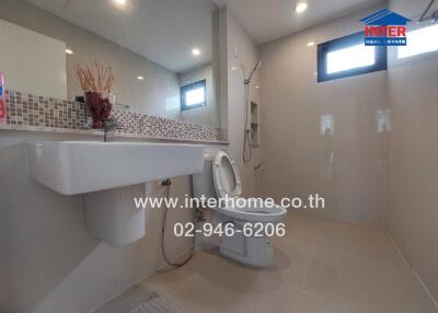 Modern bathroom with large mirror and sleek fixtures