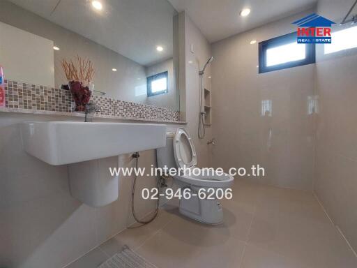 Modern bathroom with large mirror and sleek fixtures