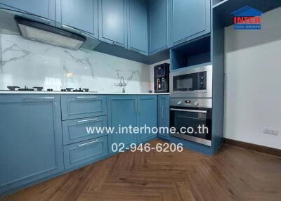 Modern kitchen with blue cabinets and built-in appliances