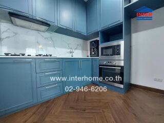 Modern kitchen with blue cabinets and built-in appliances