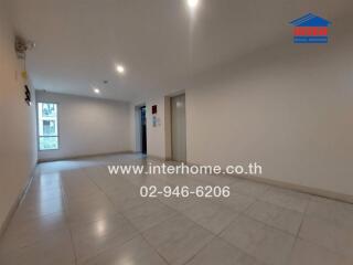 Empty hallway with tiled flooring and elevator