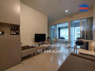 Living area with a view into the bedroom