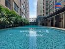 Outdoor swimming pool with adjacent apartment buildings and green plants