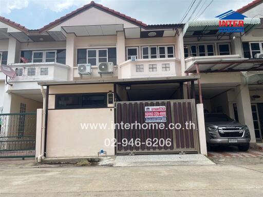 Two-story townhouse with driveway and gate