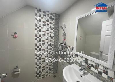 Modern bathroom with patterned tiles and white fixtures