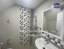 Modern bathroom with patterned tiles and white fixtures