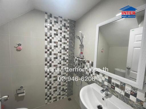 Modern bathroom with patterned tiles and white fixtures