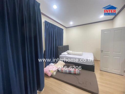 Bedroom with double bed and blue curtains