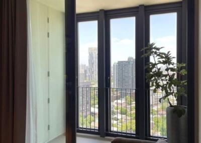 A modern living room with large glass windows offering a city view