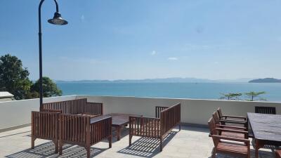 Terrace with ocean view and wooden outdoor furniture