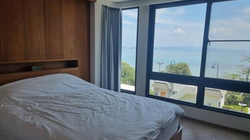 Bedroom with large window and ocean view