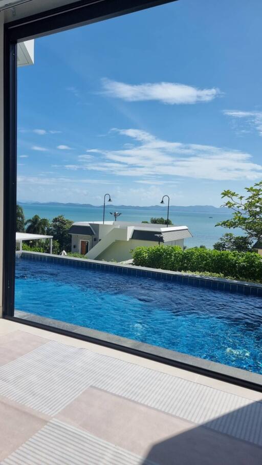 Scenic view from an outdoor area overlooking a pool and ocean