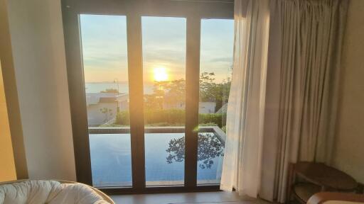 Bedroom with a scenic view and pool