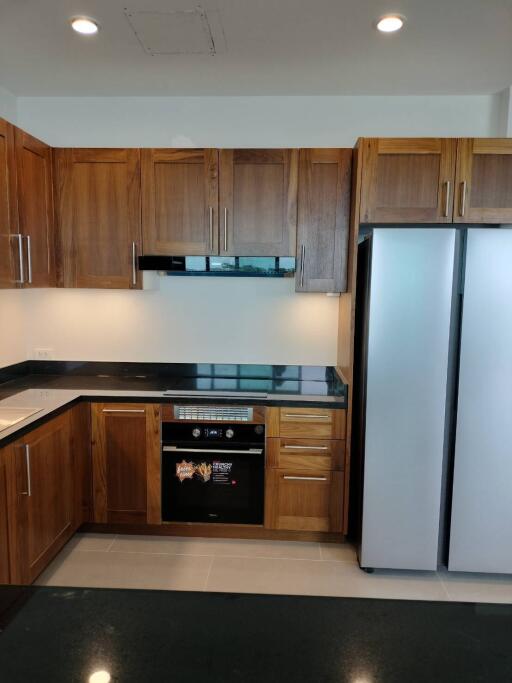 Modern kitchen with wooden cabinets and stainless steel appliances