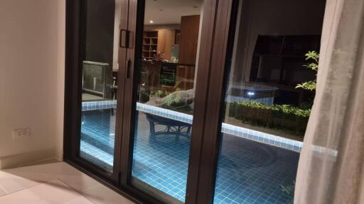 Living room with sliding glass doors leading to a pool area