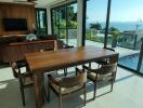 Modern dining room with a view of the pool and surrounding landscape