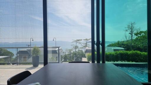 Dining area with a scenic view through large glass windows