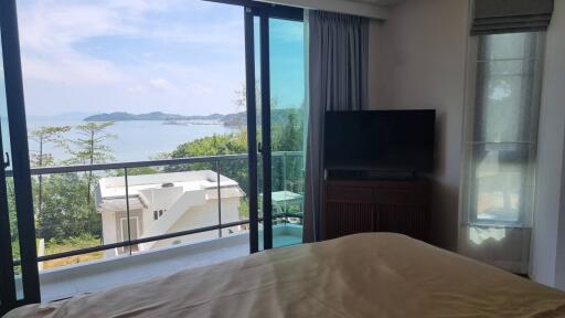 Bedroom with a scenic ocean view and balcony