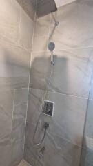 Modern shower with grey tiles