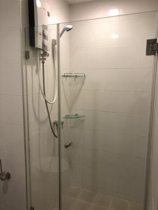 Modern bathroom shower with glass doors and white tiles