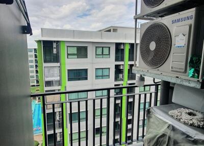 Balcony with view of modern building and air conditioning units