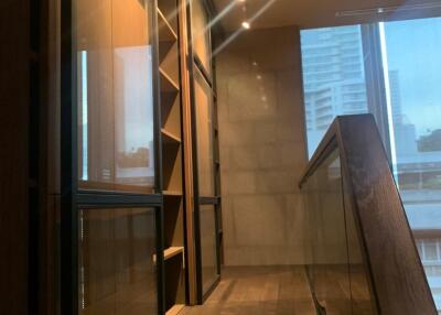 Modern hallway with wooden flooring and large windows