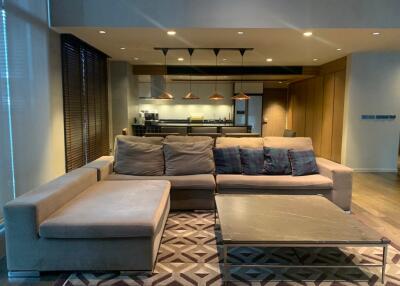 Modern living room with open kitchen and large sectional sofa