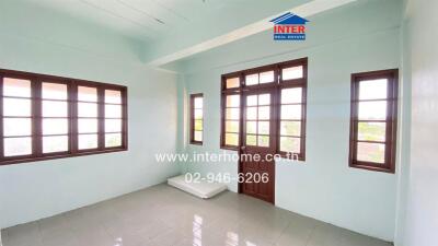 Spacious bedroom with large windows and tiled floor