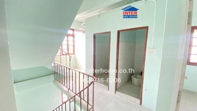 Staircase and hallway area in a building with accessible restrooms