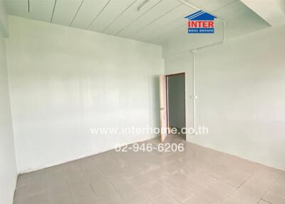 Empty room with tiled floor and open door