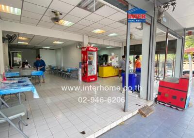 Spacious commercial area with seating, vending machines, and service counter