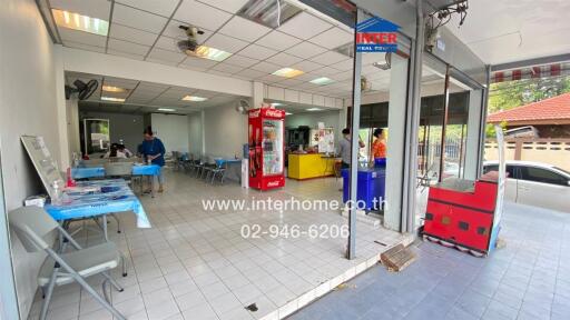 Spacious commercial area with seating, vending machines, and service counter