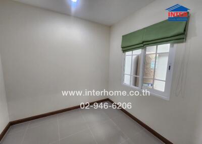 Empty bedroom with tiled floors and green window blinds