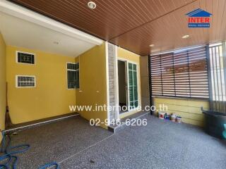 Covered balcony area with tiled floor and sliding glass door