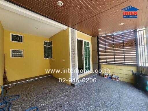 Covered balcony area with tiled floor and sliding glass door