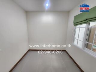 Empty bedroom with window and tiled floor