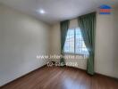 empty bedroom with wooden floor and green curtains