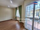 Spacious and bright living room with large windows and balcony access
