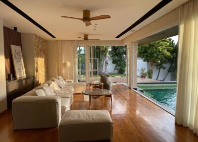 Spacious living room with poolside view