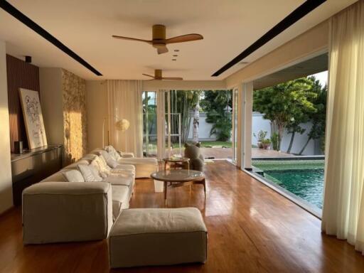 Spacious living room with poolside view