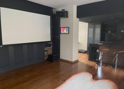 Modern living room with home theater setup and bar area
