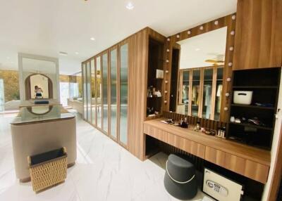 Spacious dressing room with mirrored wardrobes, vanity table, and modern decor