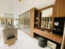 Spacious dressing room with mirrored wardrobes, vanity table, and modern decor