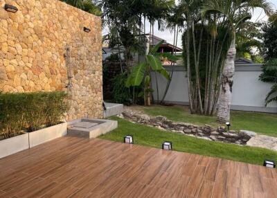 Outdoor patio with stone wall and garden